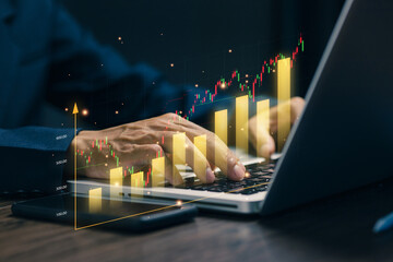 Business professional analyzing rising bar charts and stock graphs on laptop, representing financial growth, profit performance, investment success, market trend analysis.