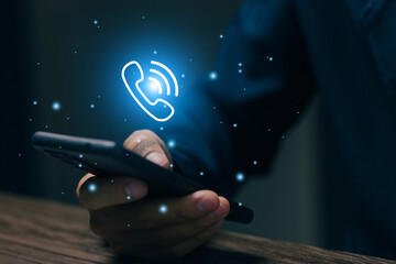 Business professional holding smartphone with call icon, representing mobile communication, digital contact service, customer support hotline, remote assistance, and modern telecom technology.