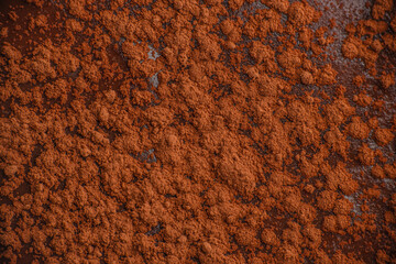 Cocoa powder texture on dark chocolate background