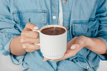 Woman holding cup of hot chocolate, cozy warm drink concept