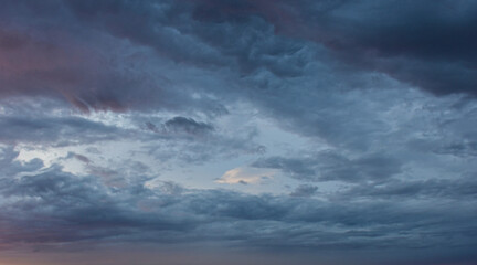 Serene blue twilight sky with light textured altocumulus cloud patterns