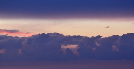 Spectacular layered sunset with brilliant yellow and deep purple bands