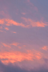 Swirling purple and grey clouds in a serene evening sky