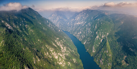 Drina River flowing through a deep canyon, surrounded by dense forests and steep mountain slopes...