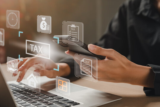 Person using smartphone and laptop for online tax filing. technology concept for digital finance, e-tax payment, accounting, and business operations. tax, online, finance, digital, e tax. accounting - Powered by Adobe