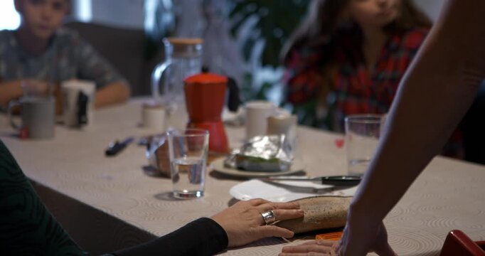 Close-up of hands organizing phones on the table to start a new vote in the app.