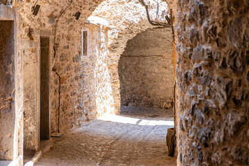 Fototapeta premium Narrow medieval alley in Mesta Village. Chios Island, Greece.