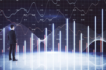 Futuristic financial analytics concept with businessman observing glowing digital stock market charts, bar graphs, candlestick patterns and data visualizations in a high‑tech virtual trading environme