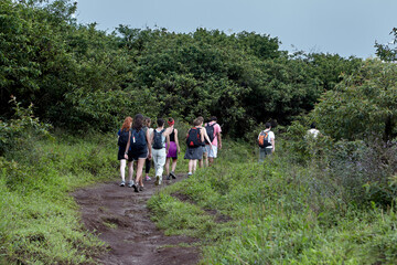 travelers hiking along the rim of Volc&aacute;n Sierra Negra on Isabela Island, the largest island in the Gal&aacute;pagos Archipelago. Sierra Negra is one of the most active volcanoes in the islands 