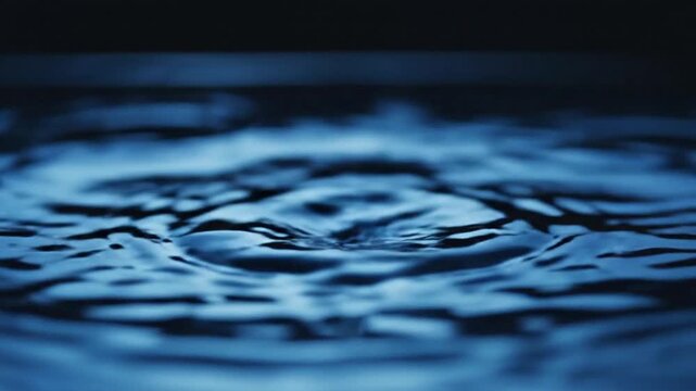 Close up of rippling blue water surface showcasing fluid motion texture and natural reflective patterns for calming background and design visuals