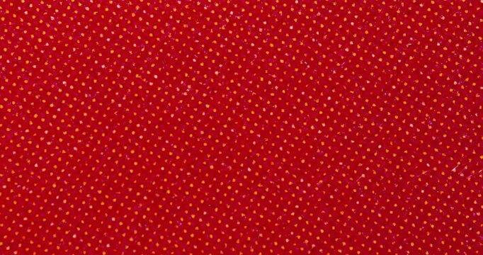 Macro close-up of a red printed paper surface with halftone dot pattern, grain and grunge noise. Abstract vintage print texture background for design, overlays and motion graphics.