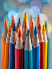 Fototapeta premium Vibrantly colored sharpened wooden pencils arranged together with a soft bokeh background creating an artistic and creative atmosphere for drawing or writing project