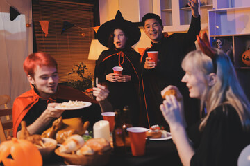 Friends enjoying a Halloween party at a bar making a toast