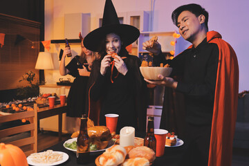 Friends enjoying a Halloween party at a bar making a toast