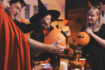 Friends enjoying a Halloween party at a bar making a toast