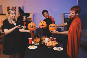 Friends enjoying a Halloween party at a bar making a toast