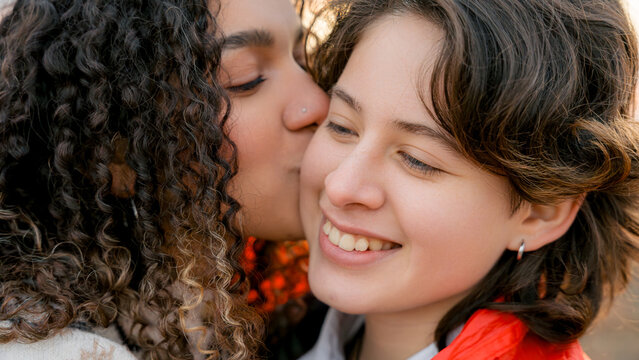 Young lesbian couple embracing LGBT pride