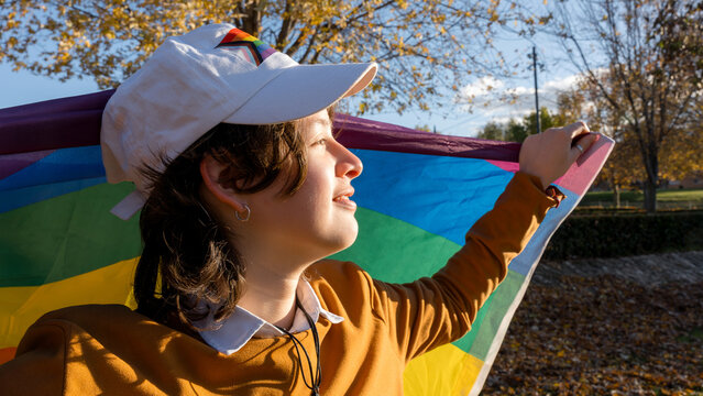 Young woman celebrating pride with a colorful flag