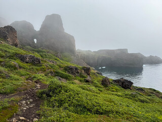 Foggy Volcanic Rock Formations on the South Coast of Disko Island, Greenland © Michel