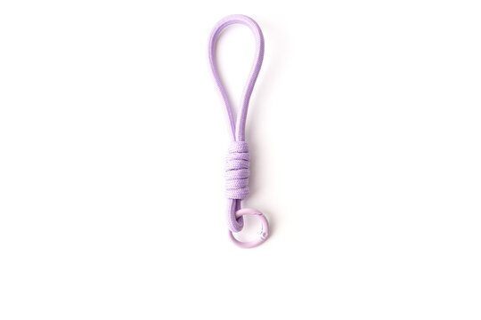 Purple paracord keychain with carabiner on white background. Minimalist accessory for tech, fashion, and lifestyle brands. Durable cord strap for keys, phone, or bags. Modern functional design