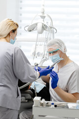 Dentist and assistant performing dental procedure on patient