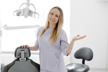Dentist smiling in her dental office next to equipment