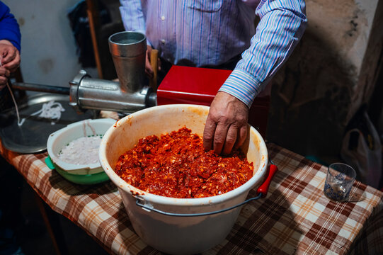 Traditional preparation of chorizo in a rural setting