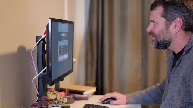 Middle Aged Man Gets Barrage of Internet of Things Smart Home Alerts While Working from Home in Remote Office - IoT Cybersecurity Concept