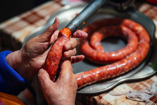 Traditional preparation of chorizo in a rural setting