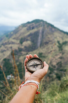 Compass guiding hand with mountain view in Sri Lanka