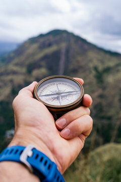 Traveler with compass exploring mountains in Sri Lanka