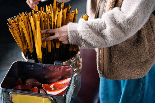 Person picking kau chim sticks at temple in Taiwan