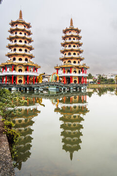 Twin pagodas reflecting in calm lotus pond