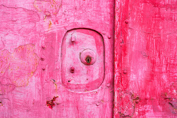 Weathered pink door texture with peeling paint in Taiwan