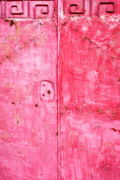 Textured pink metal door with ornate pattern in Taiwan