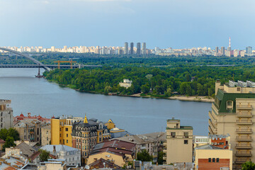 Kyiv capital of Ukraine city scape wide angle panorama living district buildings along Dnieper river aerial drone photography