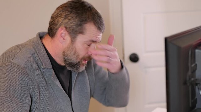 Middle Aged Man Gets Barrage of Internet of Things Smart Home Alerts While Working from Home in Remote Office - IoT Cybersecurity Concept