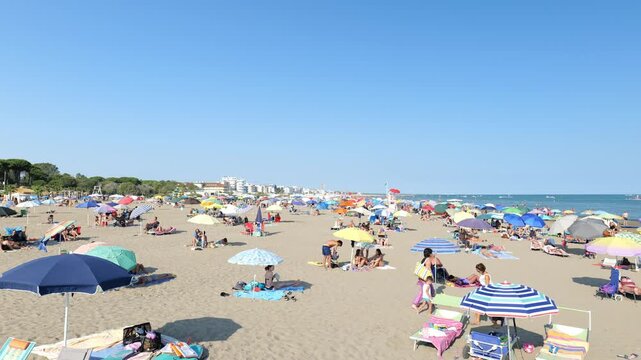 A view of a busy beach near the sea. Adriatic Sea. Vacation in Italy