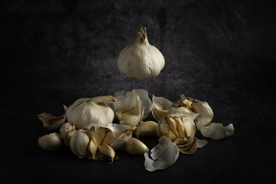 Garlic bulb levitating above a dark background