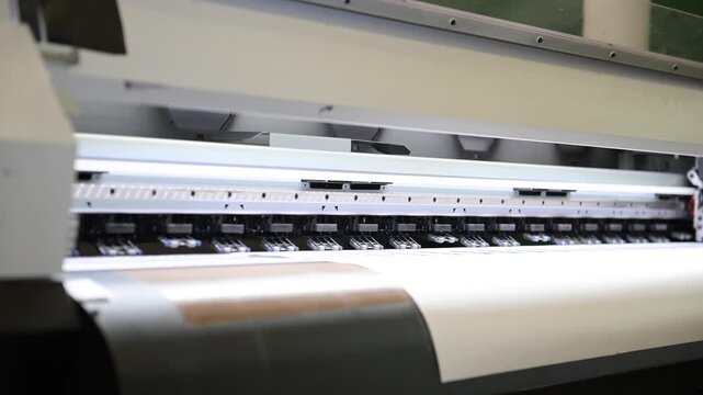 The process of printing a large-format printer in the production workshop of the printing house. Production of printing products