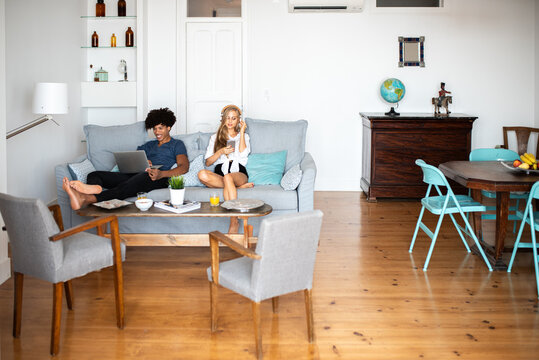Relaxed multiethnic couple enjoying leisure time at home