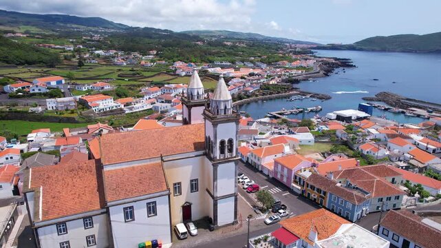 AZORES - 11.3.2025 - Amazing aerial footage circling the back of a church on a waterfront parish on the Azores' Terceira Island.
