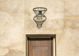 Small historic stone house facade with basketball hoop