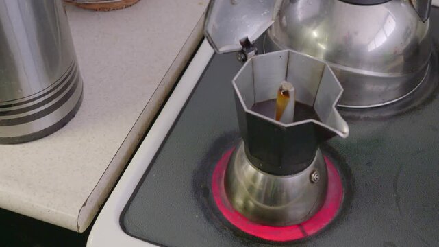 High-angle view, close-up shot of the moment when the water reaches its maximum temperature to offer a delicious cup of coffee.