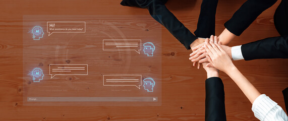 A modern business team collaborates on artificial intelligence ideas at a wooden desk. Their hands indicate unity and teamwork while discussing digital innovations. Trope