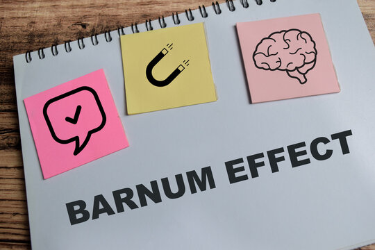 Concept of Barnum effect write on book isolated on Wooden Table.