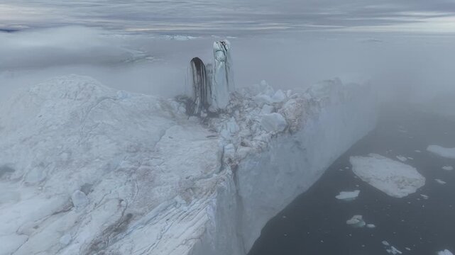 GREENLAND - 11.4.2025 - Stunning aerial footage starting to circle counterclockwise around an iceberg on Greenland's Disko Bay.