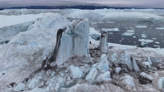 GREENLAND - 11.4.2025 - Excellent aerial footage pulling back from a large iceberg in Greenland's Disko Bay.