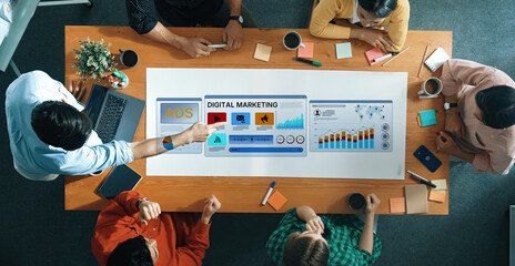 A diverse team collaborates on digital marketing strategies, analyzing performance metrics and data in a modern office setting, enhancing business growth and innovation. Trope