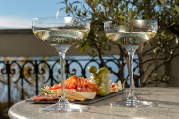 Outdoor Patio Gourmet charcuterie board with meats prosciutto ham, salami, green olives and cheese...